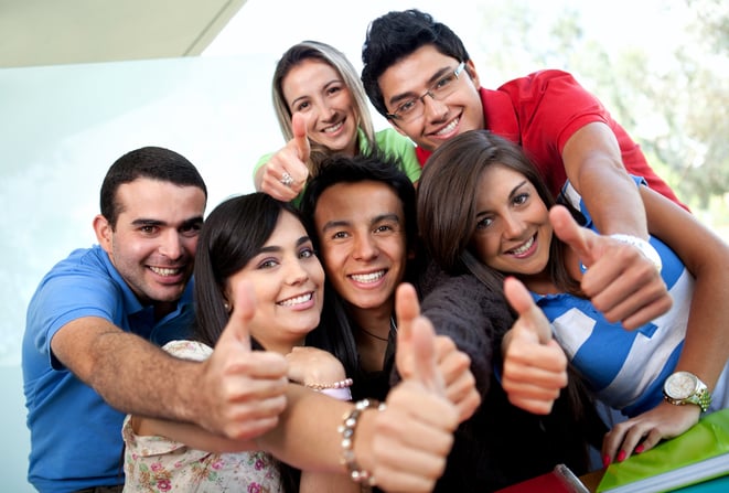 Group of students at the university with thumbs up