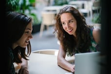 two-women-engaged-over-laptop