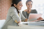 two-women-looking-at-tablet-for-web