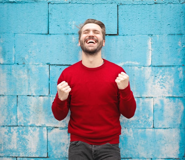 man clenching fists with joy